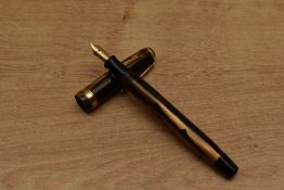 A Parker Duofold Geometric (Toothbrush) button fill fountain pen in Gold and Black with broad cap