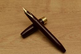 A Sheaffer Pen For Men III Snorkel fill fountain pen in Burgundy with gold trim having Sheaffer