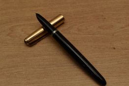 A Parker 51 aerometric fill fountain pen in Black with gold filled converging line cap. Circa 1950
