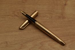A Waterman converter fill fountain pen in gold plated ribbed pattern having 14CT nib. Circa 1973