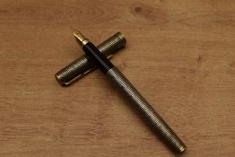 A Parker Premier converter fill fountain pen in Sterling Silver Cisele with gold trim having