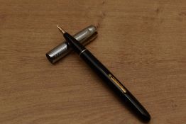 A Waterman Taperite lever fill fountain pen in Black with a chrome lined cap having Waterman 14K