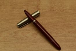 A Parker 21 Standard MkI aerometric fill fountain pen in Red with brushed steel cap. Circa 1949. A