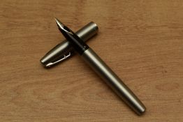 A Sheaffer Triumph 444 converter fill fountain pen in Stainless Steel having Sheaffer nib. Circa