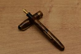 A Unique lever fill fountain pen in Brown hatching with three narrow cap bands having Warranted