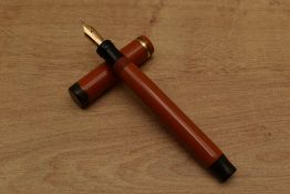 A Parker Duofold Senior Lucky Curve button fill fountain pen in Red with single cap band having