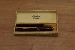A boxed Burnham lever fill fountain pen and pencil set in Rose marble with single cap band the pen