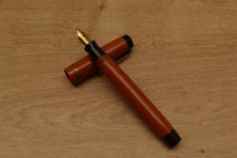 A Parker Duofold Special Streamlined button fill fountain pen in Red with two narrow cap bands