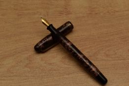 A Parker Televisor slender button fill fountain pen in Red lined with three narrow cap bands