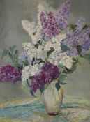 A 20th Century oil on canvas floral still life study, depicting a vase of Lilac flowers on a