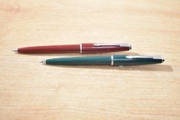 Two Parker 45 ballpoint pens one in green the other burgundy
