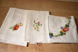 Assorted Portugese white cottons, hand embroidered with charming motifs to include apples, pears,