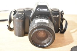 A Canon EF-M camera with Canon 35-80mm in Hama camera bag
