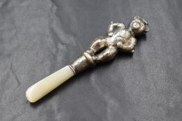 A George V silver baby's rattle, the bear motif rattle on a mother-of-pearl handle, marks for