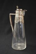 An Edwardian silver mounted claret jug, of tapering cylindrical form having a silver mounted top