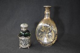 A George VI silver mounted glass decanter, of triangular form having thistle motifs to the body,