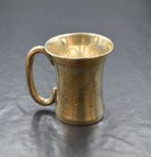 A George V silver cup, having a flared rim and c-curve handle, having decorative engraving and '