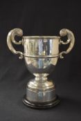 A George V silver trophy, of traditional form having a moulded rim and two scroll handles,