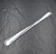 A George III silver tongue depressor, having a narrow centre with a smaller end opposed by a