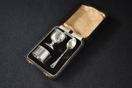 A cased Elizabeth II silver christening set, comprising an egg cup, napkin ring and teaspoon,