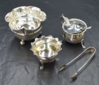 An Edwardian silver sugar bowl, having a lobed rim raised on three ball feet, marks for Birmingham