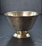 A Victorian silver bowl, having engraved flora and fauna decoration, raised on a circular foot,