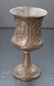 A Victorian silver chalice, of bulbous form having a flared rim with embossed panels of foliate