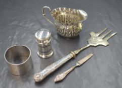 A Victorian silver cream jug, of oval form having a crimped rim and embossed foliate decoration,