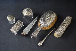 A Victorian Silver hairbrush having berry and floral decoration with scroll work and dog study to
