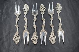 A cased set of six Elizabeth II Irish silver dessert forks, of ornate floral form with pierced