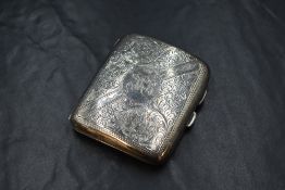 A George V silver cigarette case, of hinged rectangular form with decorative scroll engraving and '