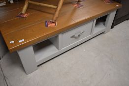 A modern coffee table having natural top and grey painted base, with drawer under, dimensions