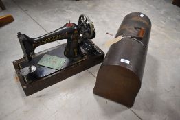 A vintage Singer sewing machine, in dome case, possibly number 99, having hand crack mechanism
