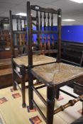 A pair of traditional rush seated ladder back chairs