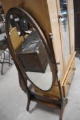 An early 20th Century oak cheval mirror