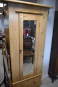 A reclaimed pine mirror door single wardrobe having shelved interior and drawer base, dimensions