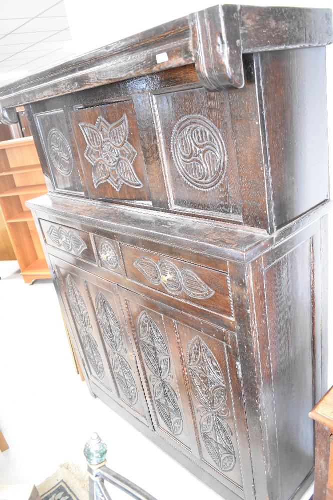 A period oak court cupboard of typical design with foliate carving throughout, dimensions approx.