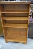 A vintage teak laminate bookshelf, dimensions approx. height 141 width 80 depth 32cm