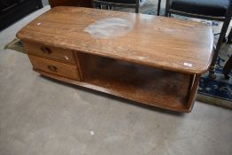 A vintage Ercol 'Pandora' style coffee table, badly stained and in need of restoration, though sound