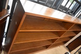 A solid golden oak double book shelf labelled Arthur W Simpson, The Handicrafts , Kendal
