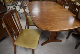 A vintage G plan oval extending dining table and set of four similar dining chairs , closed size