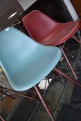 A pair of modern designer chairs, by Vitra after Eames, having dark maple legs, in ocean and oxide