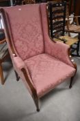 An Edwardian mahogany framed easy armchair having later pink floral upholstery, width approx. 72cm