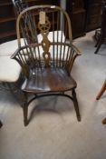 A traditional wheelback Windsor style carver chair with rinoline stretcher