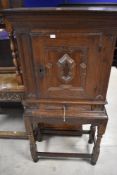 A 19th Century oak cupboard on stand , the cupboard having shelved interior and drawer under,
