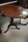 A 19th Century mahogany pedestal table having circular lipped top on turned column and triple