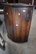 A 19th Century oak bow fronted corner cupboard, height approx. 89cm