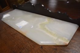 An Onyx sidetable or cabinet top having canted front, width approx. 83cm