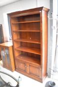 A modern oak bookshelf of deep proportions, width double cupboard under, dimensions approx. Height