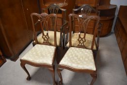 A pair of reproduction Chippendale style dining chair having ball and claw feet and a pair of
